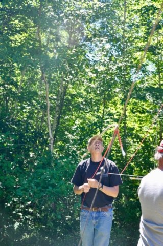 Alan K1MZM Watches carefully as dipole antennas are hauled high into the trees
