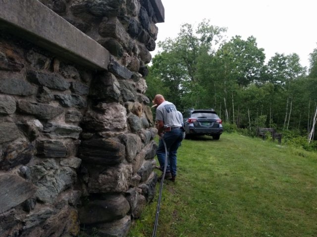 Chris KI1P runs hardline coax around the tower base.